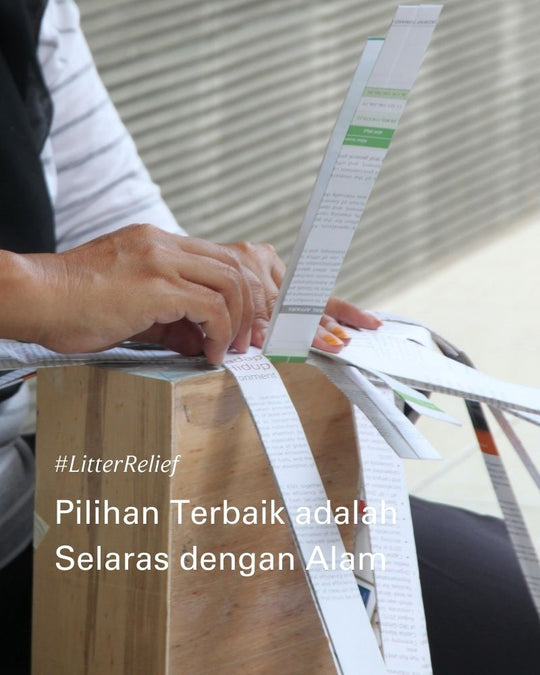 a woman weaving recycled paper